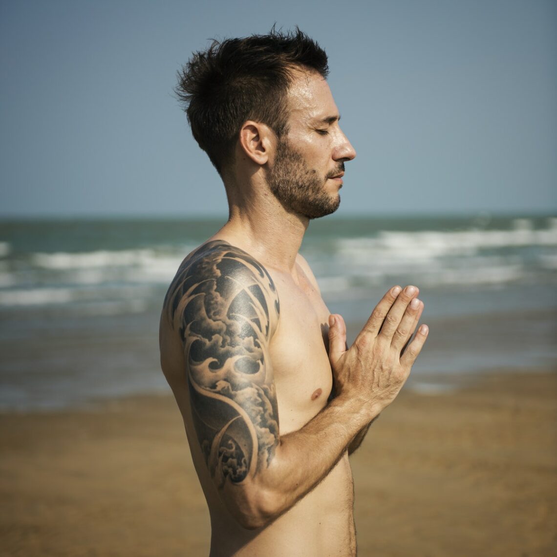 man-performing-yoga-on-beach-jaywalker