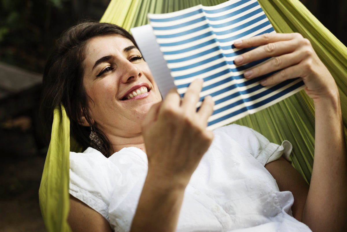 lady in a hammock reading a book