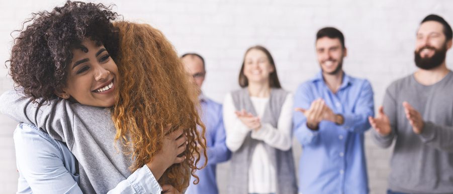 Trust exercise. Cheerful people hugging during group therapy session, panorama, free space