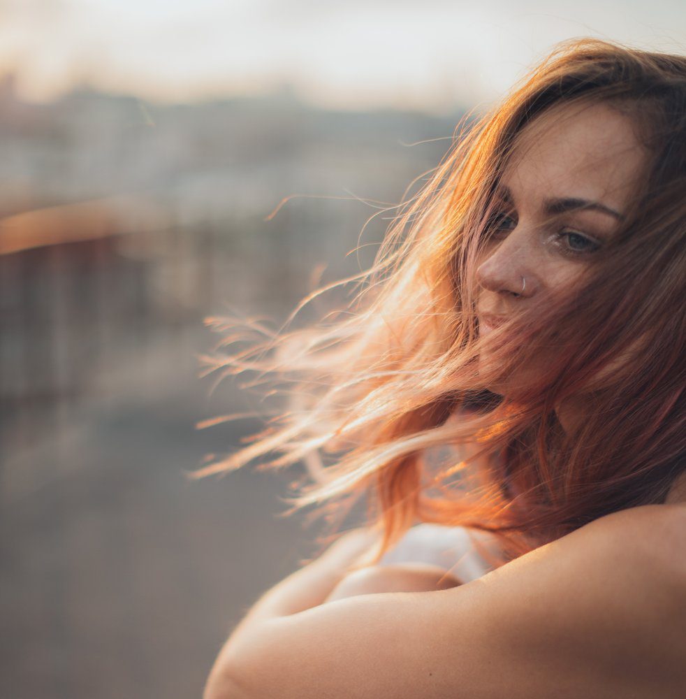 happy woman with the wind blowing against her hair