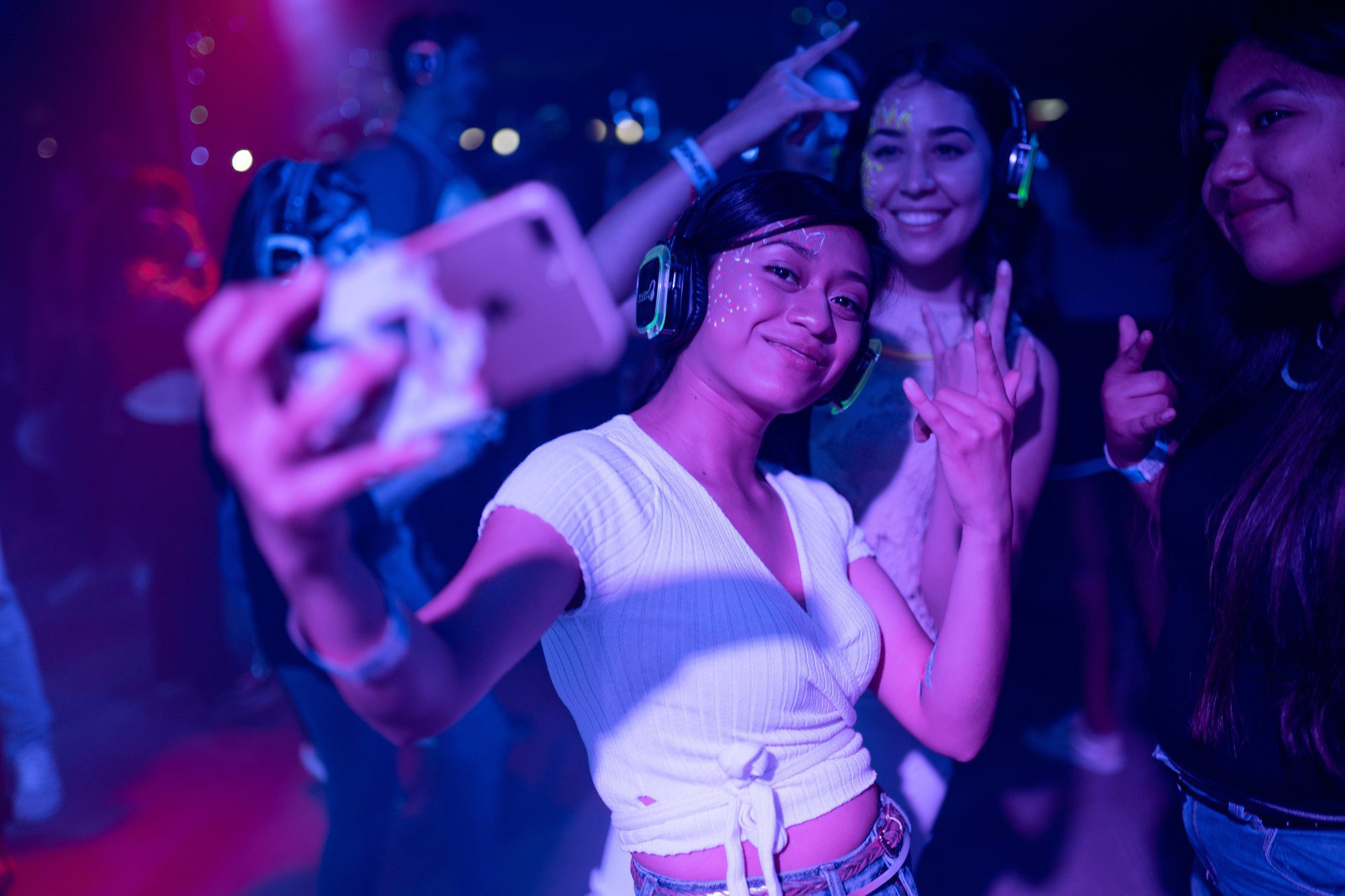 female teenager taking a selfie at a party