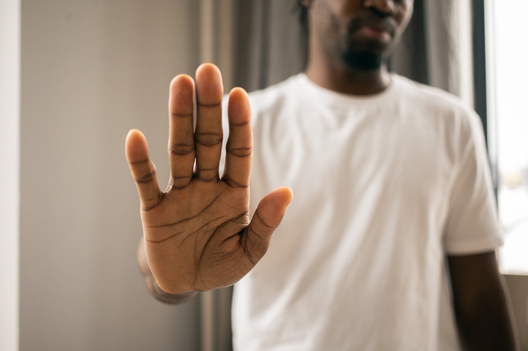 man making a stop hand gesture