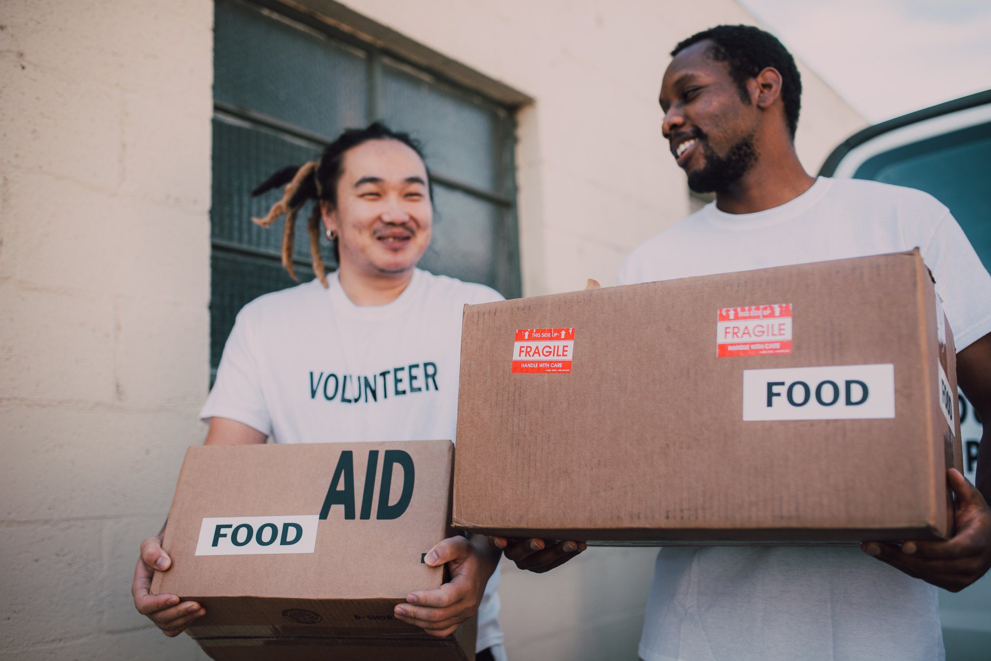 two man carrying aid boxes