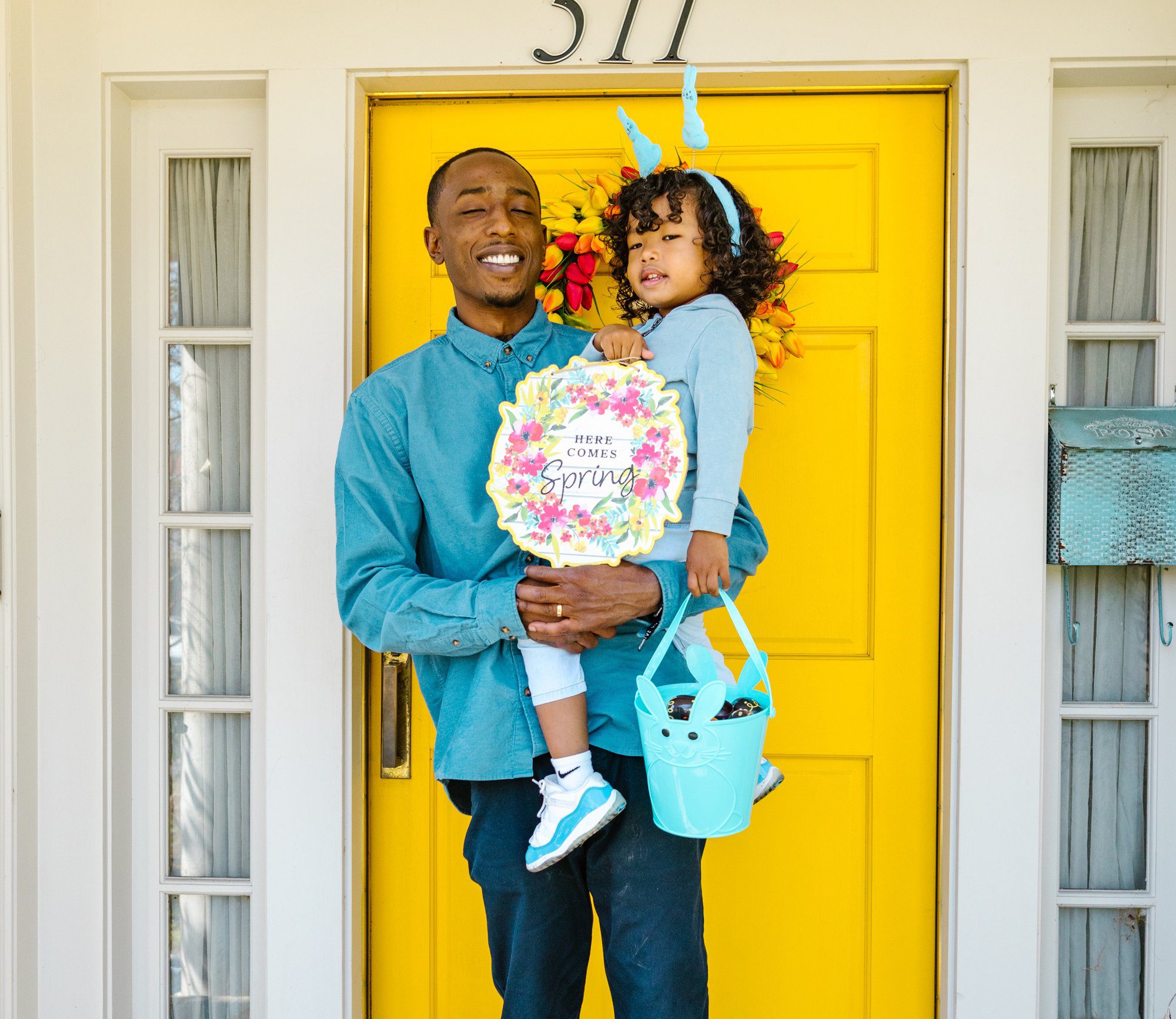 father holding his daughter on the doorstep