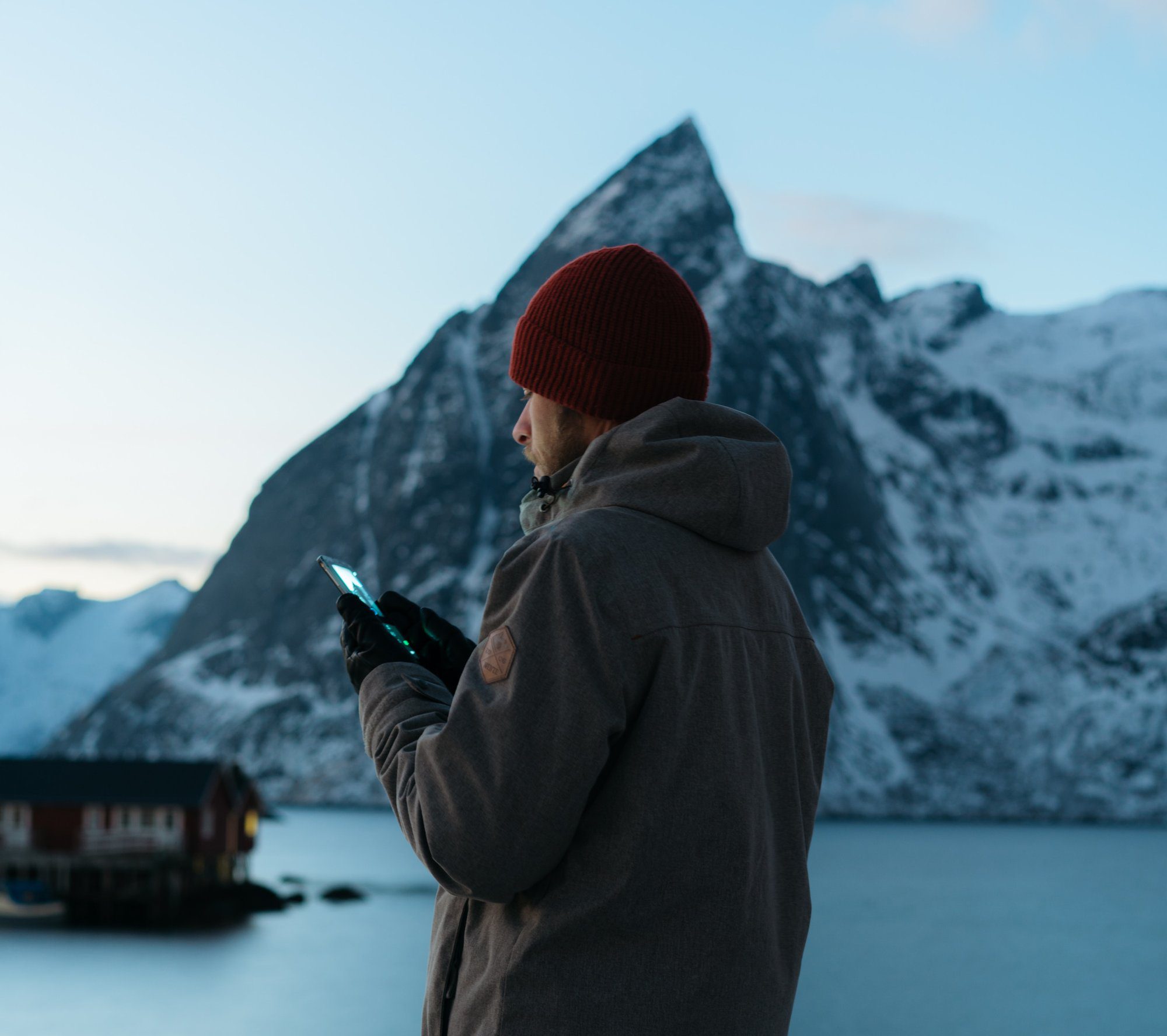 lonely man using mobile device during winter