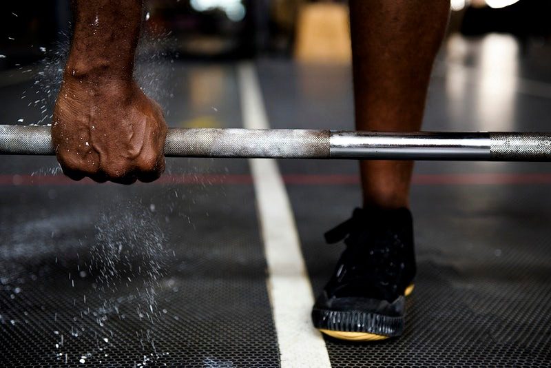 An athlete addicted to performance-enhancing drugs is lifting weights.